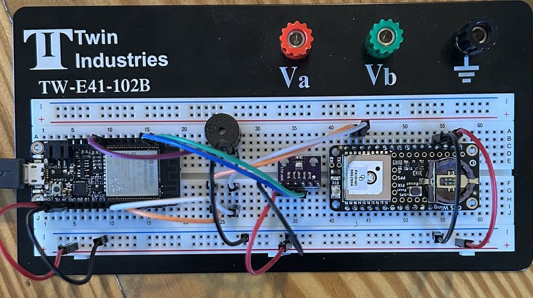 Breadboard prototype with the ESP32 microcontroller, GPS module, pressure sensor, and buzzer